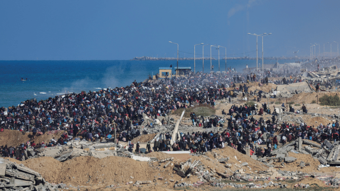 Palestinians, who were displaced to the south at Israel's order during the war, make their way back to their homes in northern Gaza, amid a ceasefire between Israel and Hamas, near Gaza City this January | File Photo | Reuters/Ramadan Abed/File Photo