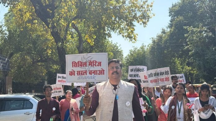 Asif Iqbal, co-founder of the NGO Dhanak, leads a peaceful Valentine’s Day march with interfaith and intercaste couples at New Delhi’s ITO | Photo: Mrinalini Dhyani, ThePrint