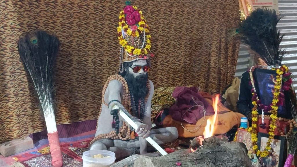 A Naga sadhu with elaborate headgear, adorned with Rudraksha beads and LED lights | Krishan Murari | ThePrint