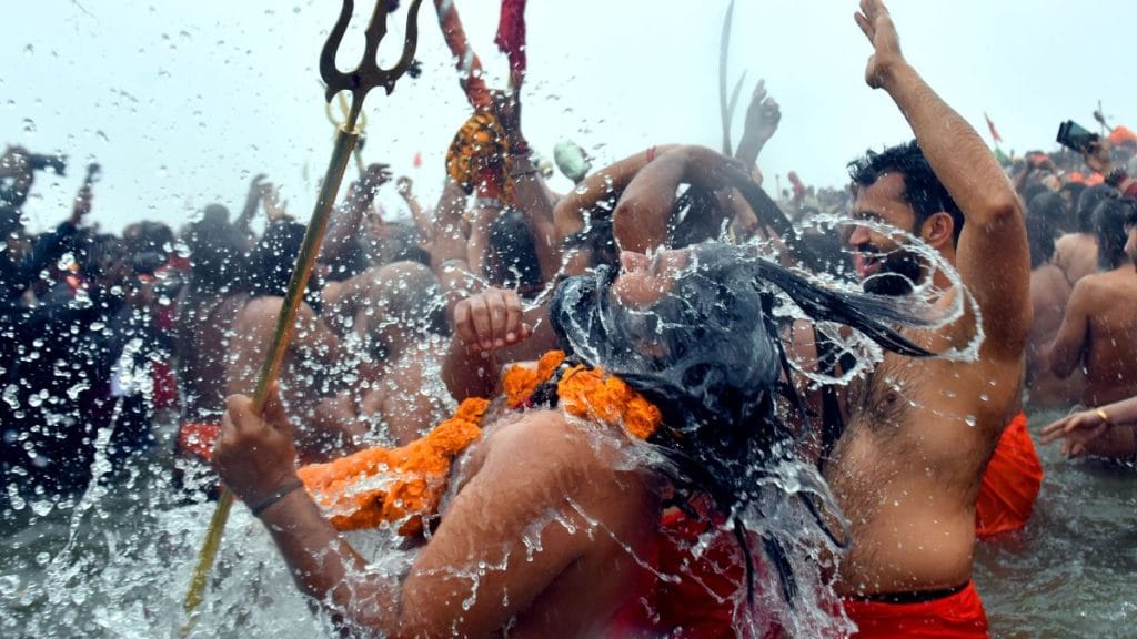 On the day of Shahi Snan, Naga Sadhus took a dip in the Ganga along with their weapons. | Suraj Singh Bisht | ThePrint