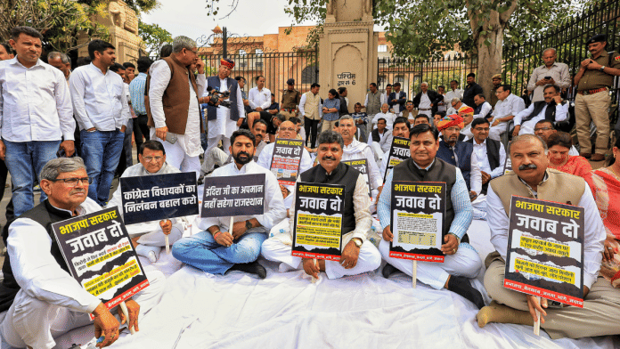 Rajasthan Congress President Govind Singh Dotasra, Leader of Opposition Tikaram Jully and party MLAs sit on dharna as they protest outside the state Assembly against suspension of their MLAs from the Assembly and against a state minister's alleged remarks against former prime minister Indira Gandhi, in Jaipur, Thursday, Feb. 27, 2025