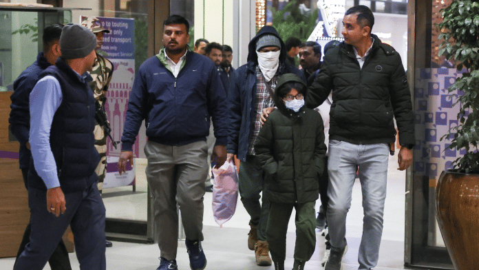 Security personnel escort Indian immigrants deported from the U.S., as they leave the airport in Ahmedabad, India February 6, 2025 | Reuters