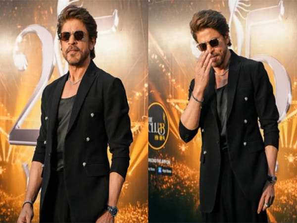 SRK stuns in all-black look at IIFA 2025 green carpet, greets fans with 'adaab'