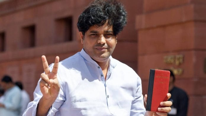 Congress MP Imran Pratapgarhi holds a copy of the Constitution and shows a victory sign at Parliament House in New Delhi Friday | Photo: ANI