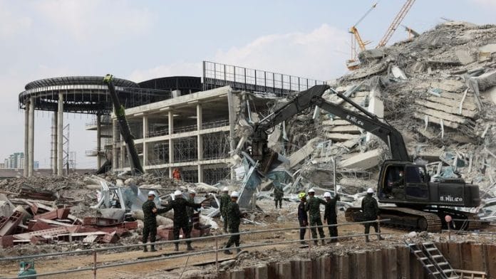 Rescue personnel work at the site of a building that collapsed, following a strong earthquake, in Bangkok, Thailand, March 29, 2025. REUTERS/Chalinee Thirasupa
