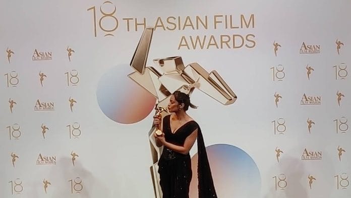 Shahana Goswami kisses her trophy after winning Best Actress award for the film Santosh at 18th Asian Film Awards ceremony in Hong Kong Sunday | Photo: Heena Fatima | ThePrint