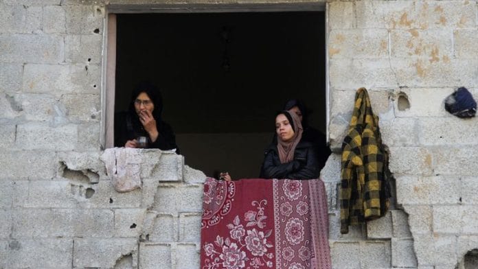 Representational Image | Palestinian women stand in a window of a damaged building, amid ceasefire negotiations with Israel, in Gaza City | Reuters/Mahmoud Issa