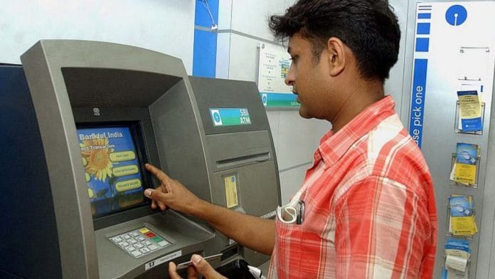 Representational image | A customers uses a ATM machine | STR/Bloomberg News