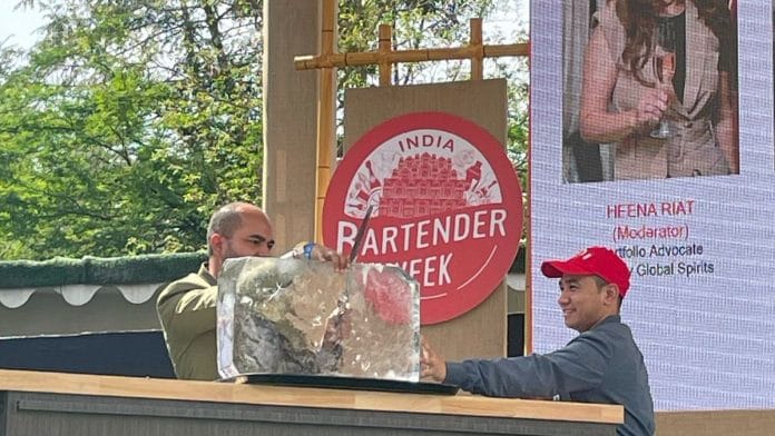 Annu Kumar carves out a cube of ice for a Suntory Toki highball | Triya Gulati, ThePrint