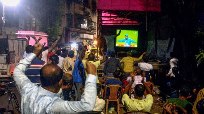 File photo of people gathering to watch cricket on TV | ANI