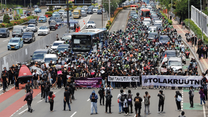 People take part in a protest against revisions to the country's military law, which will allocate more civilian posts for military officers, outside the Indonesian parliament, in Jakarta, Indonesia, March 20, 2025 | Reuters