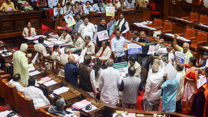 BJP and JDS members hold placards in protest demanding a judicial probe by a sitting High Court judge into the alleged �honey-trap� attempt involving a minister and other politicians, during the Budget session of Karnataka Assembly, in Bengaluru, Friday, March 21, 2025 | PTI