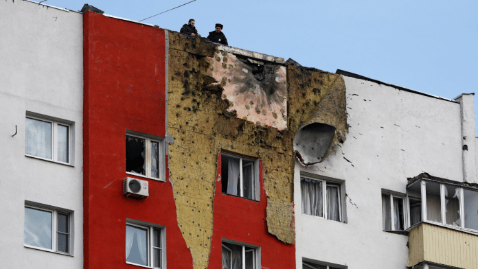 Police officers stand on the roof of a multi-storey residential building damaged in a recent Ukrainian drone attack, according to local authorities, in the course of Russia-Ukraine conflict, in Moscow, Russia March 11, 2025 | Reuters