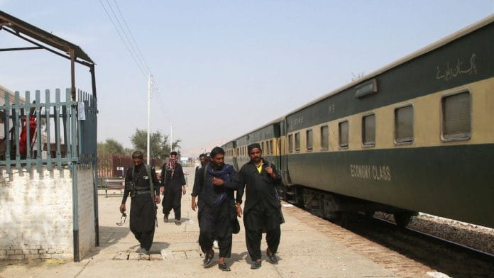 Police officers walk next to a rescue train, after the attack on Jaffar Express by separatist militants in Bolan, at the Railway Station in Mushkaf, Balochistan, Pakistan | 12 March, 2025 | Reuters