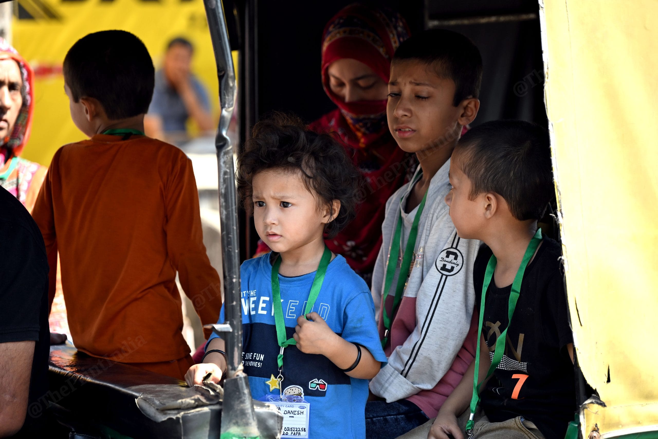The children are wearing I-cards bearing their father's name and number because their mother cannot cross the border due to having an Indian passport | Photo: Suraj Singh Bisht, ThePrint