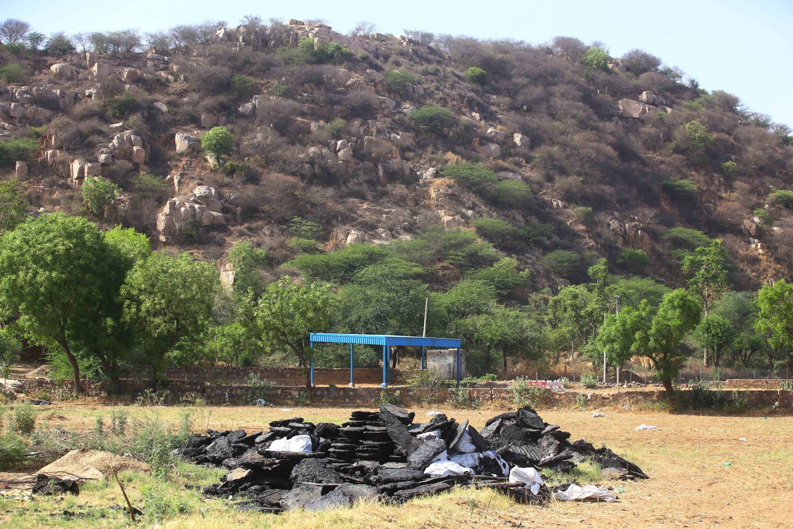 A pile of 'gulla', produced by burning plastic and scrap waste, which is sold for profit