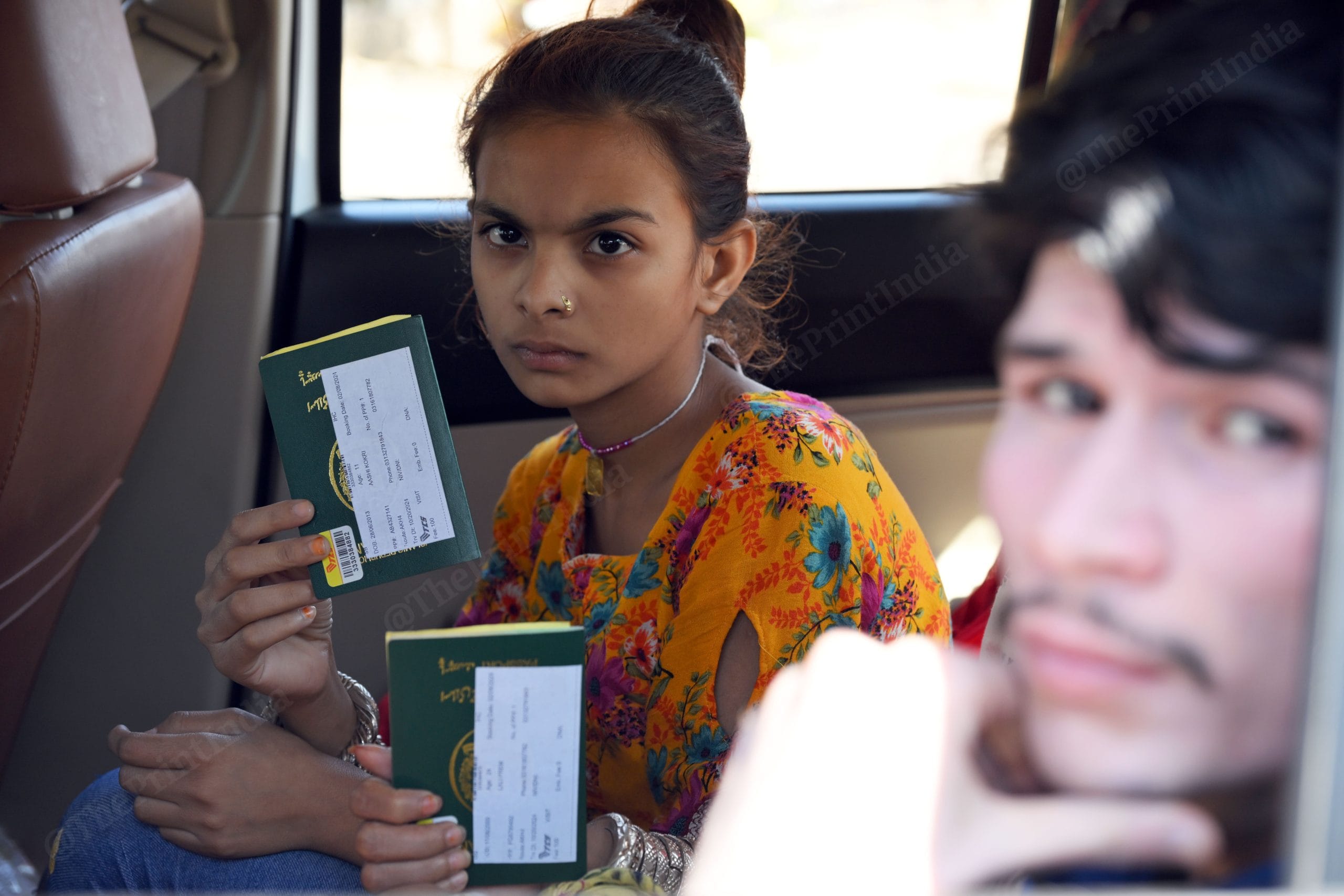 A kid showing his pakistani passport while waiting for their turn to get inside near Attari- Wagah Border check post | Photo: Suraj Singh Bisht, ThePrint