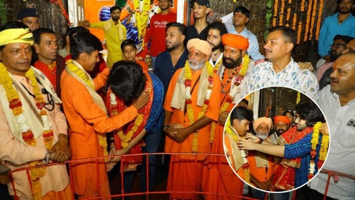 Rudraksh Shukla touching the feet of the priest at the Dewas temple. | By special arrangement
