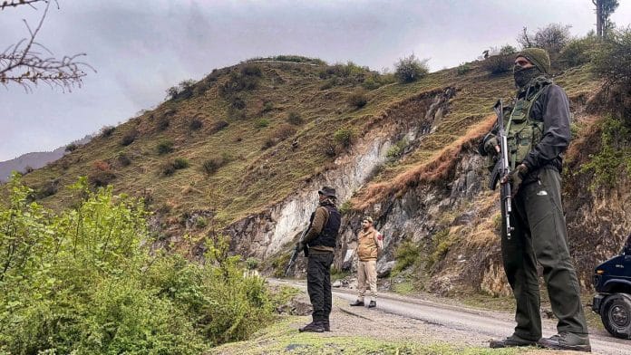 Security personnel stand guard at the Chatru forest area, after one terrorist was killed in an encounter with security forces, in Kishtwar district, Friday/PTI