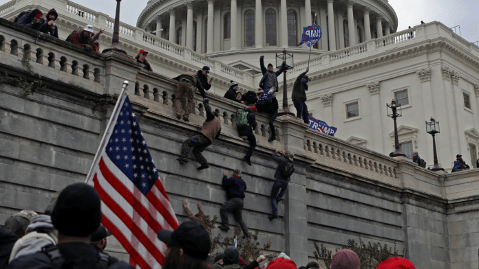 Supporters of U.S. President Donald Trump climb a wall during a protest against the certification of the 2020 presidential election results by the Congress, at the Capitol in Washington, U.S., January 6, 2021. Picture taken January 6, 2021 | Reuters file photo