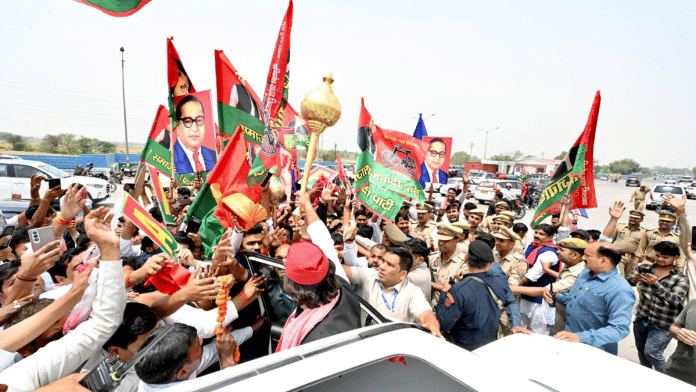Samajwadi Party chief Akhilesh Yadav (wearing red cap) is greeted by supporters on his arrival in Agra on Saturday | X/@yadavakhilesh