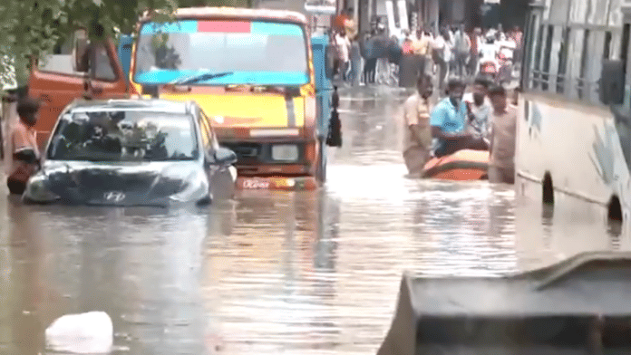 Cars partially submerged amid heavily waterlogged roads due to incessant rains in Sai Layout area, Bengaluru on 19 May 2025. | ANI