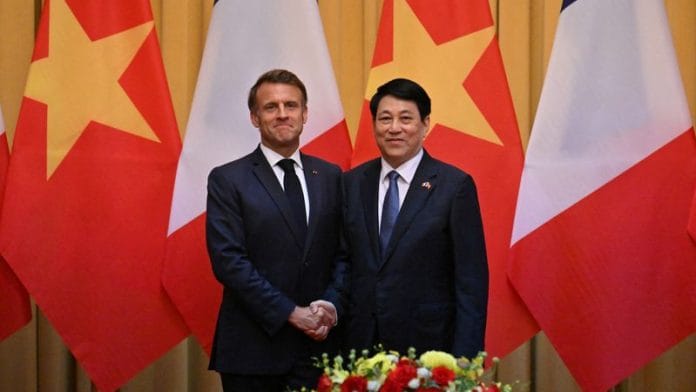 France's President Emmanuel Macron and Vietnam's President Luong Cuong shake hands during a meeting at the Presidential Palace in Hanoi on 26 May 2025. | Nhac Nguyen | Pool via Reuters