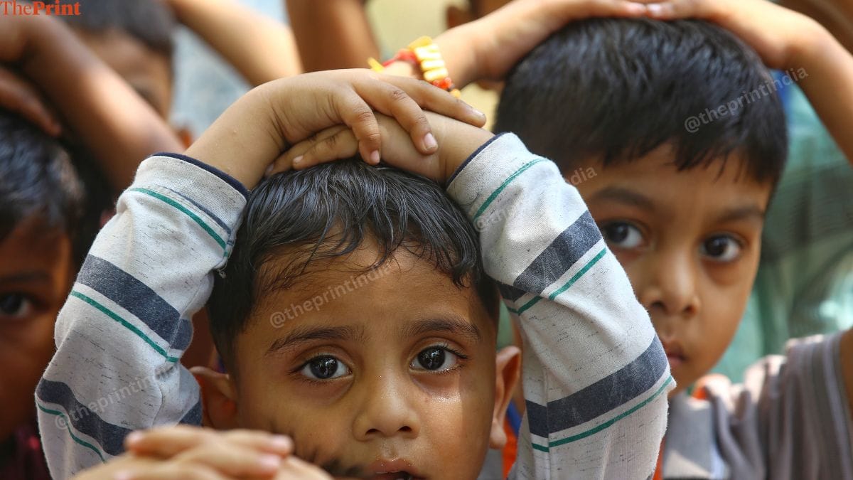 Students use their hands to cover their heads. | Manisha Mondal | ThePrint