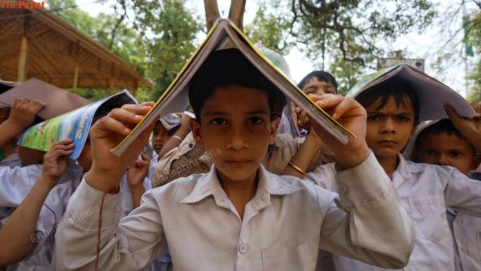 Students cover their head with book and notebooks as part of a mock drill. | Manisha Mondal | ThePrint