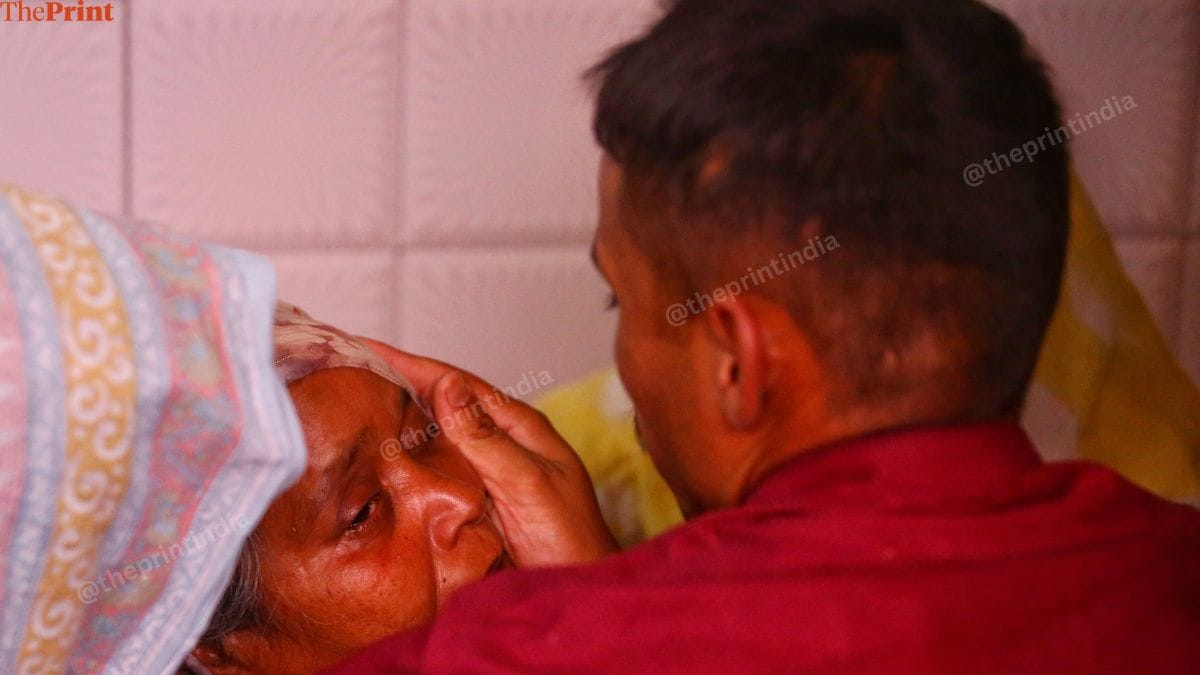 Dinesh's brother, Kapil, consoles his mother. | Manisha Mondal | ThePrint