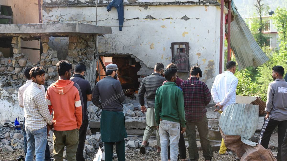 Residents look at a structure damaged by shelling in Surankote | Suraj Singh Bisht | ThePrint