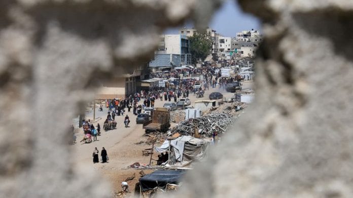 Palestinians make their way with belongings as they flee their homes after the Israeli military issued orders for evacuation from eastern Khan Younis, in the southern Gaza Strip | Reuters/Hatem Khaled