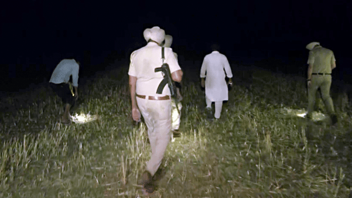 Police personnel search for debris of drone neutralised in Amritsar Friday. | ANI