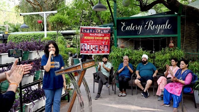 Shalu Malik, one of the founding members of the Dhoom Machalo group, performing at the karaoke event | Suraj Singh Bisht, ThePrint