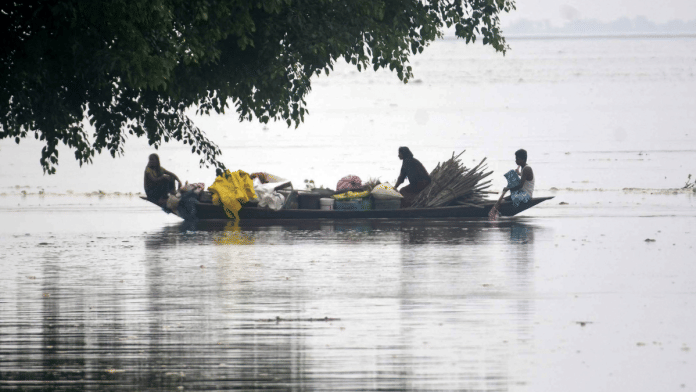 Flood-affected villagers with their belongings move to safer places by a boat, at Hiloikhunda village in Darrang on 3 June 2025. | ANI