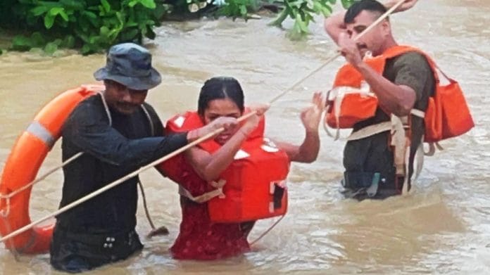Personnel from Assam Rifles are seen rescuing victims from inundated areas, during a flood relief operation on Monday. (ANI Photo)