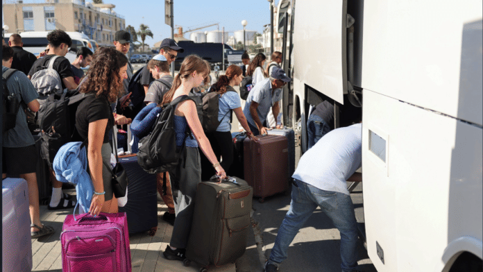 Passengers from the Crown Iris, a cruise ship, board buses from the port of Larnaca, Cyprus, June 18, 2025 | Reuters