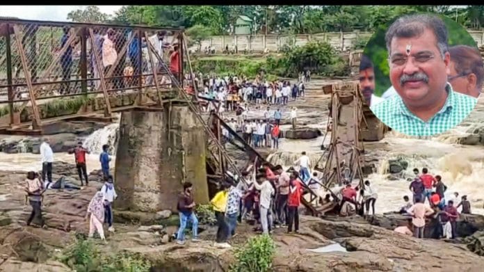 People stand near an iron bridge over the Indrayani river after it collapsed, in Pune district, Maharashtra, Sunday, June 15, 2025. Some people are feared to have been swept away after the collapse | PTI