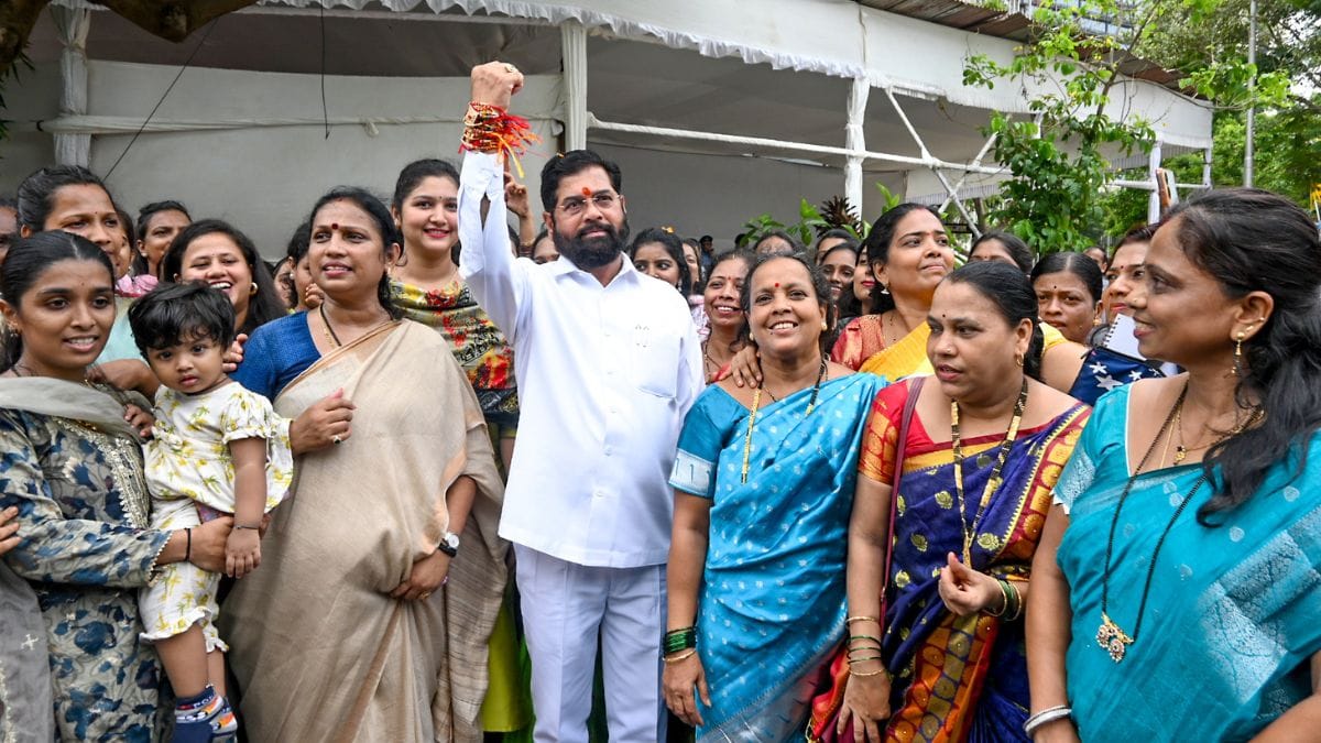 Women tie rakhi to Mahrashtra CM Eknath Shinde after launch of 'Mukhyamantri Majhi Ladki Bahin' scheme at Vidhan Bhavan in Mumbai on 29 June, 2024 | Photo: ANI