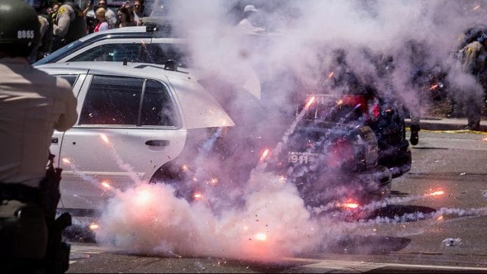 A firework explodes after being thrown at police during a standoff with protesters following multiple detentions by Immigration and Customs Enforcement (ICE), in Los Angeles County of Paramount on 7 June 2025. | Barbara Davidson | Reuters