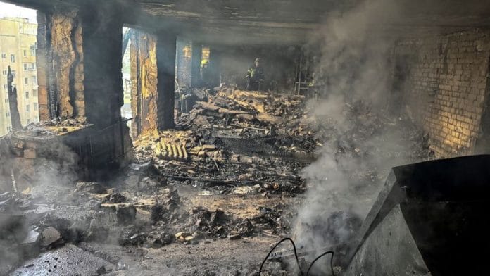 Firefighters work inside an apartment building hit by a Russian drone strike, amid Russia's attack on Ukraine, in Kharkiv, Ukraine on 7 June 2025. | Vitalii Hnidyi | Reuters