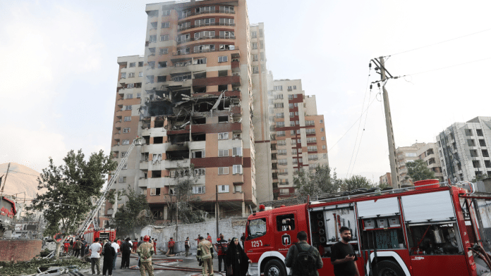 Firefighters work at the scene of a damaged building in the aftermath of Israeli strikes, in Tehran | Majid Asgaripour/WANA (West Asia News Agency) via REUTERS