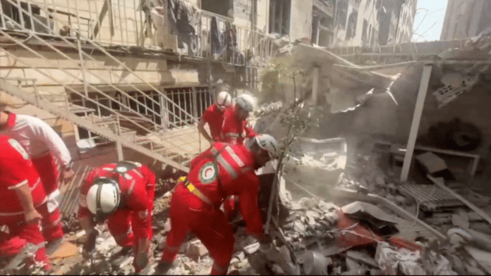 Rescuers working at the site of a damaged building, in the aftermath of Israeli strikes, in Tehran | Credit: Iranian Red Crescent Society/Handout via Reuters