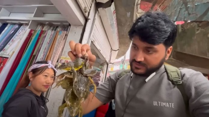 YouTuber Yatra Guru Ji holding up frogs