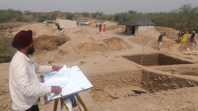 A person capturing the essence of the ancient ruins at Agroha, blending art and archaeology