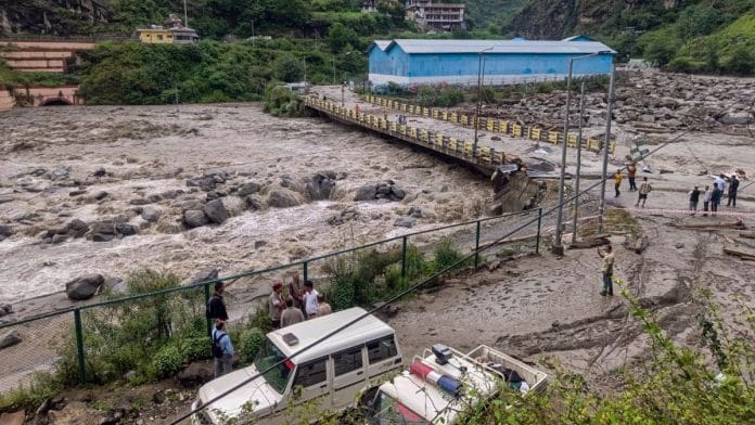 People stand near a damaged area at Sainj valley amid flash floods following cloudbursts in Kullu district, Himachal Pradesh, 25 June, 2025 | PTI