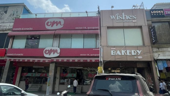 Exterior view of Om Sweets and adjoining Wishes by Om outlet in Sector 14, Gurugram.