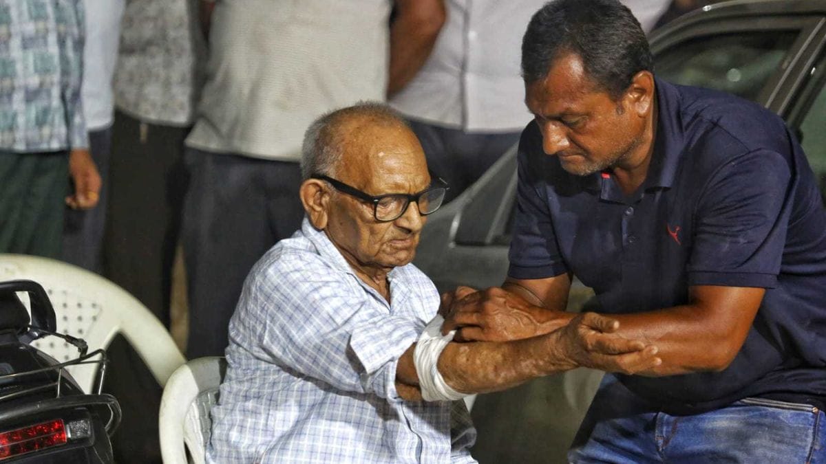 Ramanbhai Patel sits with his arm stretched out as a blood sample is drawn. He has come searching for his granddaughter, Nirali | Praveen Jain | ThePrint