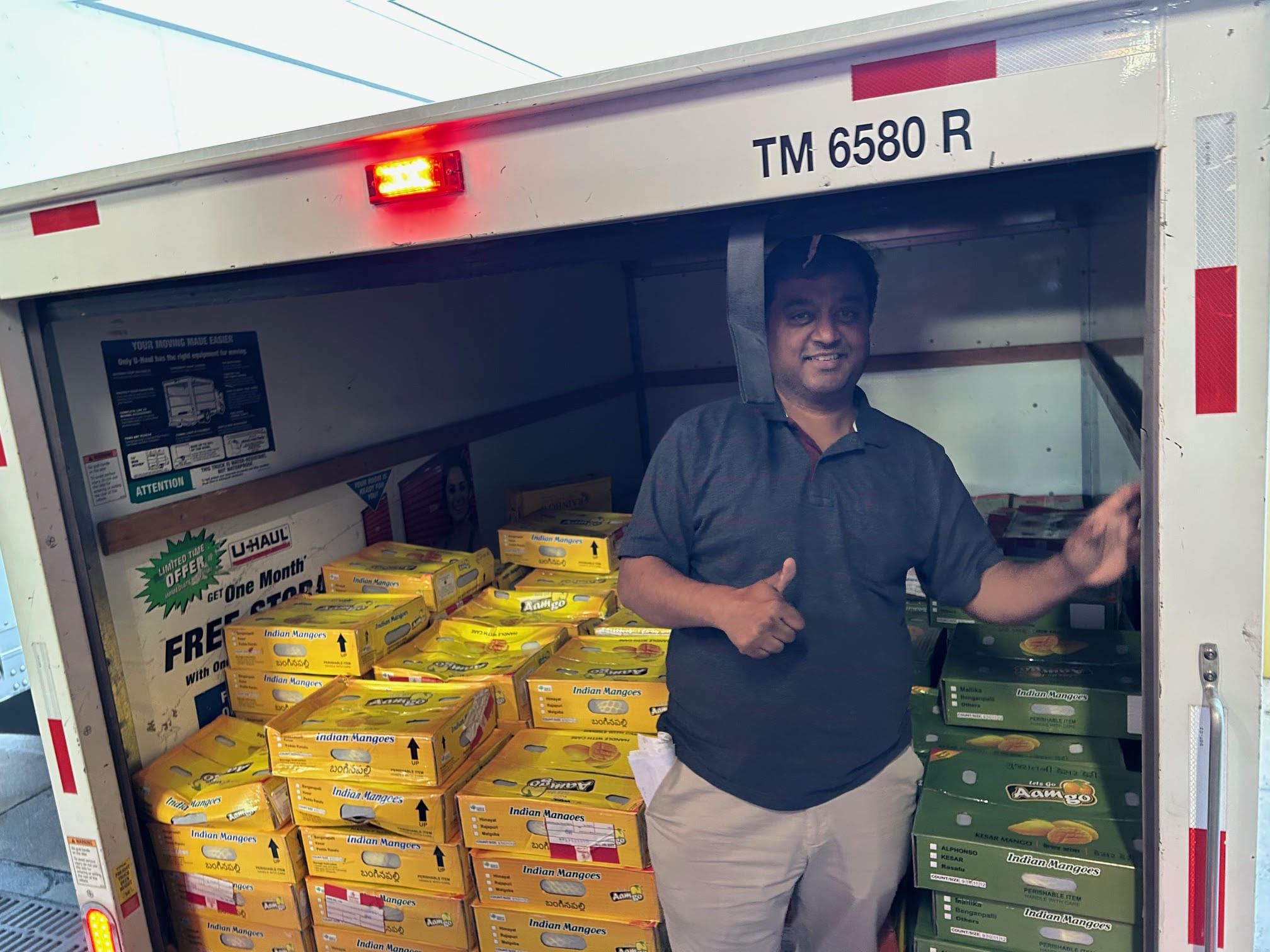 Gola loading a rental truck with mangoes
