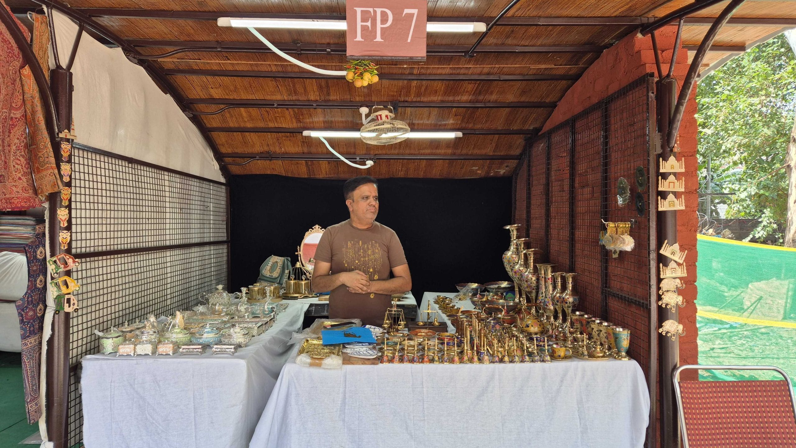 Nadeem sells brass products at Dilli Haat exhibition